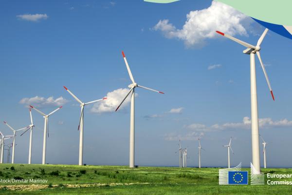The stock image shows rows of windmills in a large windfarm with green fields and blue skies